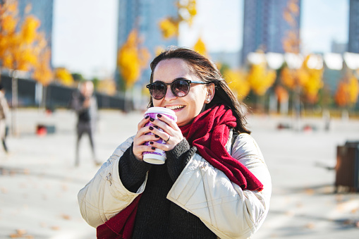 Young adult plus size woman walking in autumn park