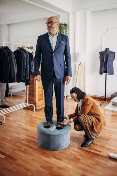 istock Tailor taking measurements for new suit 1410161294