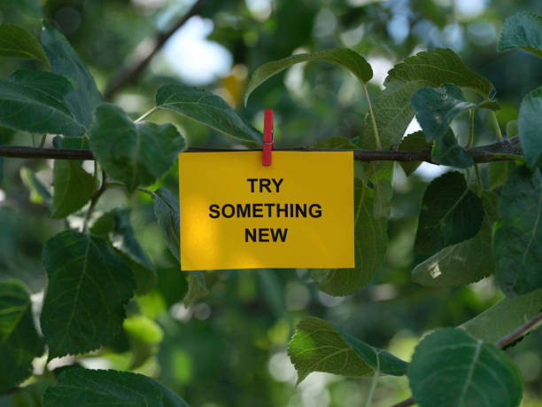 istock A paper note with the phrase Try Something New on it attached to a tree with a clothes pin 1410161641