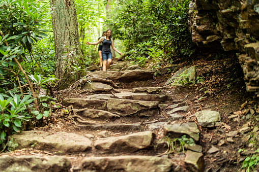 A group of teenage girls walk down the rock path to the Glen Onoko waterfall in Jim Thorpe, Pennsylvania.