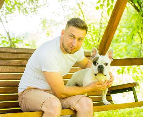 portrait of a man with a french bulldog