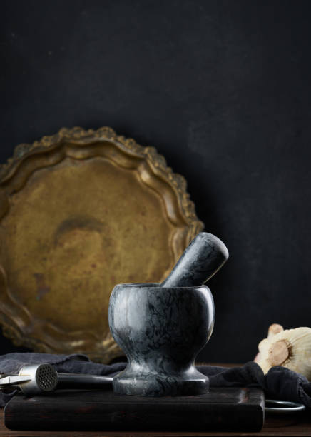 istock Black stone mortar on a wooden table 1410164148