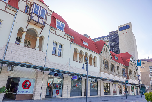 Gathemann's Complex on Independence Avenue in Windhoek at Khomas Region, Namibia, with Erkraths Building on the right and many other shops visible. Luisen Pharmacy is the oldest pharmacy in Windhoek. The buildings were designed by Willi Sander between 1902-1910.