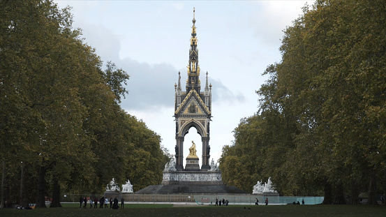 Beautiful view of the golden Albert Memorial surrounded by large green trees in Kensington gardens, London, UK. England landmarks