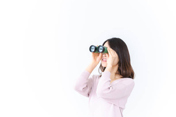 istock Young woman looking into the distance with binoculars 1410170308