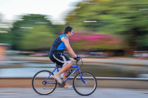 Porto Alegre, Rio Grande do Sul, Brazil - Jan 27th, 2012: Young man riding a bike at Redemption Park. Motion blur. Blurred background