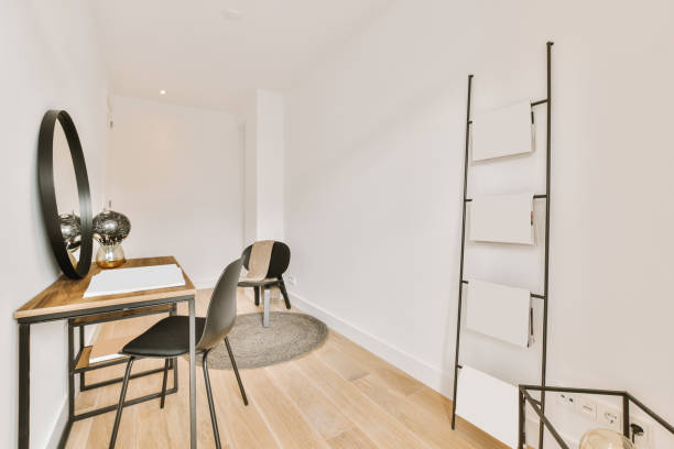 istock A small room with a table and chair and a round mirror 1410174762