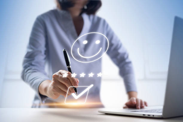 istock Satisfaction and customer service survey concept, business people using  laptop. to answer the questionnaire And the satisfaction rating, the satisfaction rating with the smiley face icon 5 stars. 1410174780