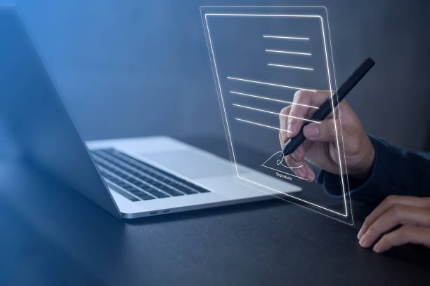 istock Businessman work from home handling documents E-signing, signing digital contracts electronic signing electronic signature through internet technology document data management smart contract agreement 1410174788