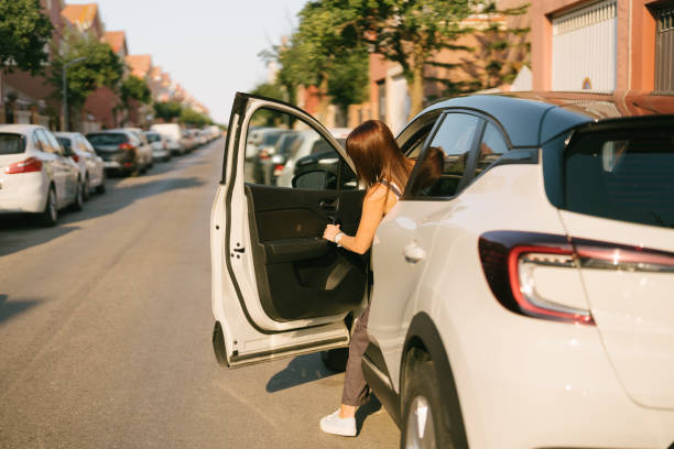 istock rear view of a woman getting into a car 1410177817