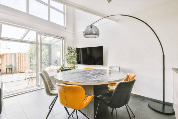 istock A simple table with chairs, located under an elegant chandelier 1410185694