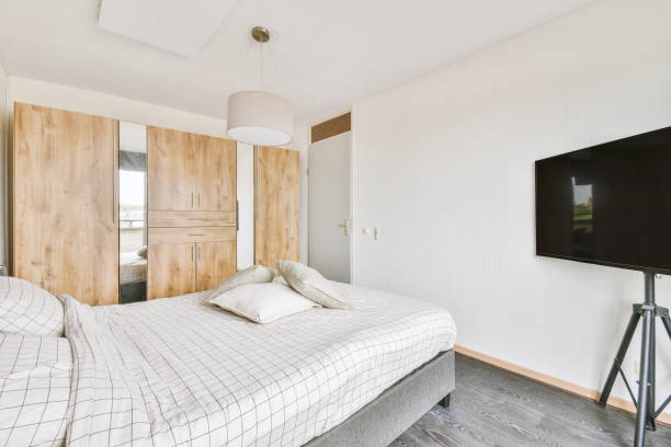 istock Bright bedroom with a big wardrobe and television 1410185724