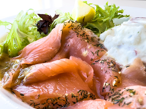 Sliced smoked salmon with potato salad