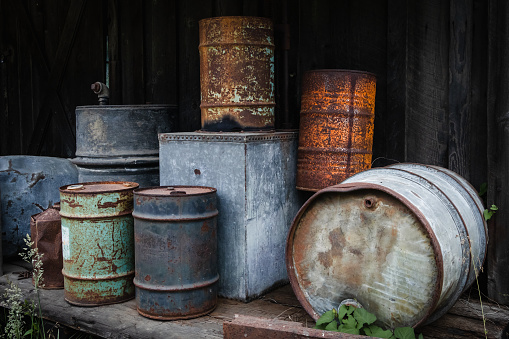 Old rusty containers used for oil and fuel storage.