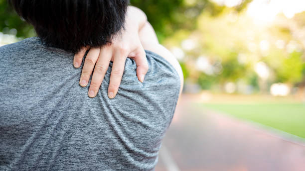 istock Asian athlete man with shoulder and neck pain 1410193650