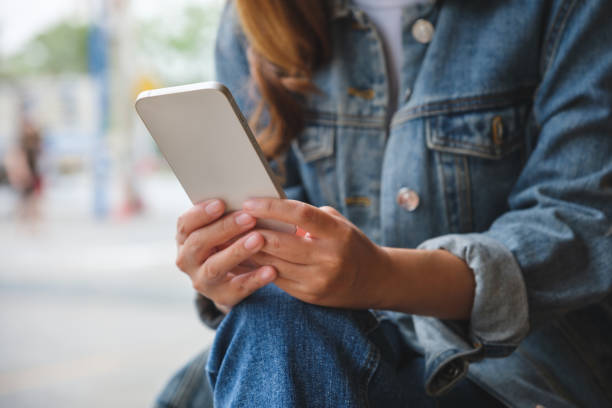 istock Closeup image of a woman holding and using mobile phone 1410196767