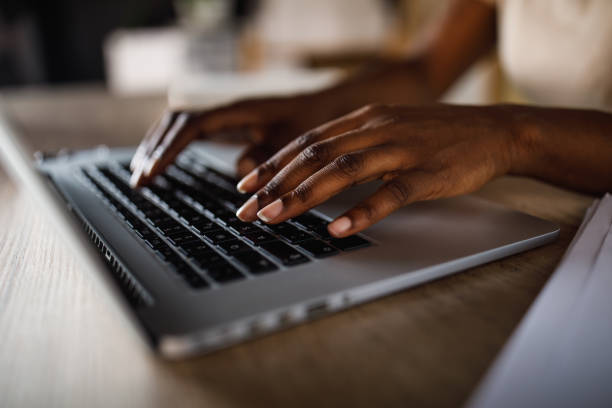 istock Unrecognizable Black woman typing data on laptop keyboard 1410196818