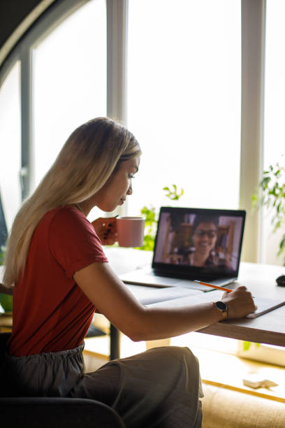 istock Young blond woman studying for exam at home office desk 1410196989