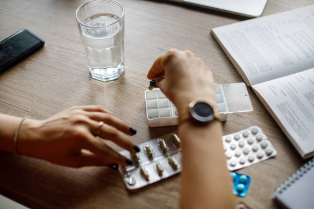 istock Arranging pills and capsules in a box for the upcoming week 1410198073