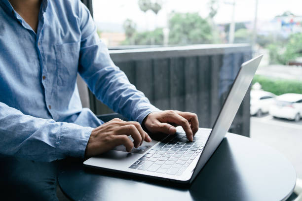 istock Businessman working in office. Man sitting wood table and using contemporary computer laptop, texting message keyboard. 1410199333