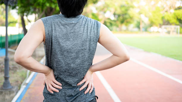 istock Lower back pain. Athlete man got injured during exercise 1410200090