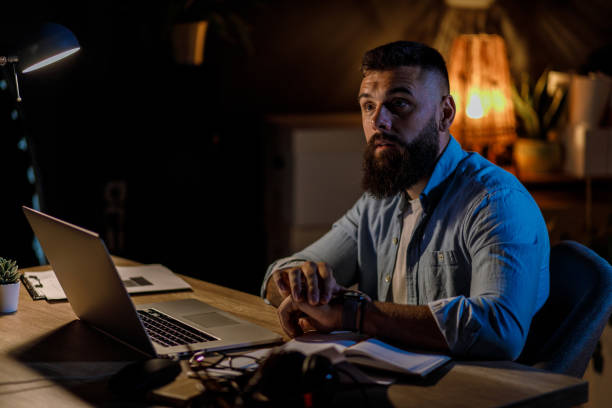 istock Businessman checking his notifications on smart watch and talking to someone off camera 1410200359