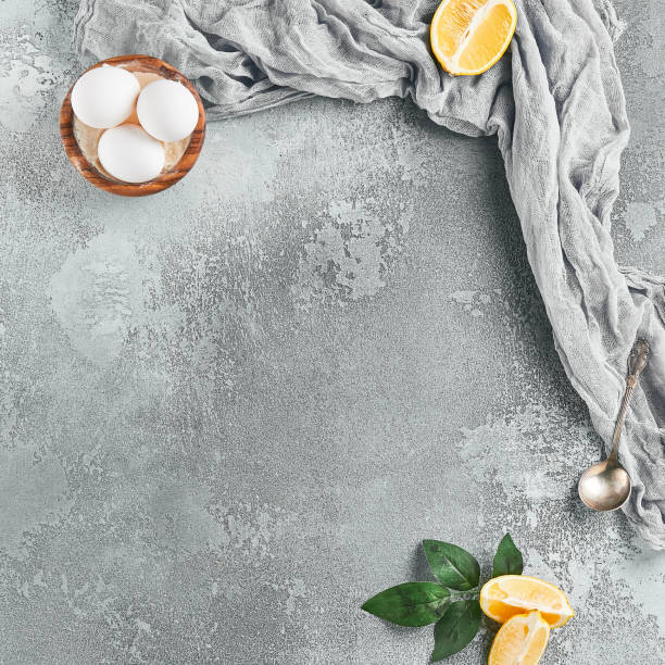 Food background with textile and lemon. Pastry composition on concrete table with empty place for design menu. Gray stone background with food elements and copy space. Food menu on concrete backdrop.