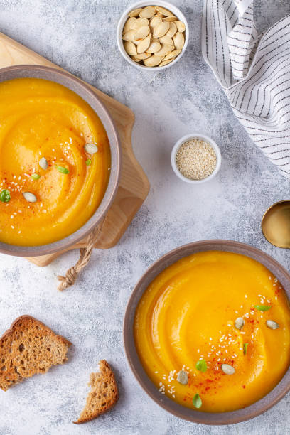 istock Pumpkin soup in tackle, top view 1410201429