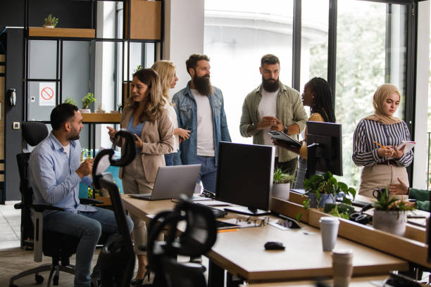 istock Diverse business colleagues hanging out at the office during coffee break 1410201443