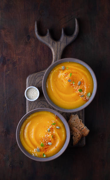 istock Pumpkin puree soup in cups, top view 1410201996
