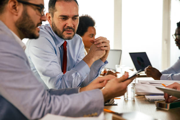 istock Two businessmen reviewing data on digital tablet during a project meeting 1410202899