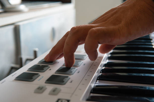 istock Black and white music keyboard with one hand using. Boy playing a keyboard. 1410203032
