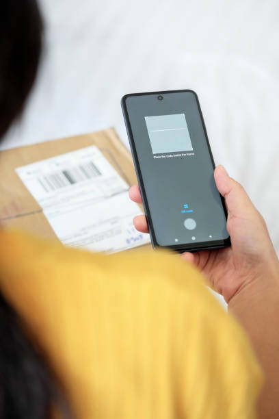 istock Scanning Barcode Of Delivery Box With Smartphone 1410205213