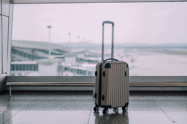 Image of silver color hand luggage in the airport terminal stock photo