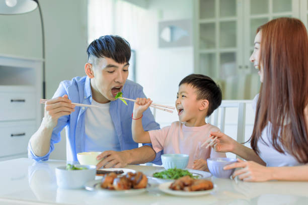 istock Happy Asian  family having dinner at home 1410208915