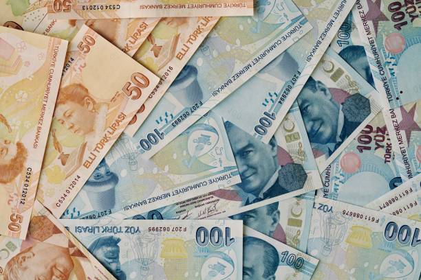 istock fifty and hundred turkish lira banknotes as a background. 1410214300