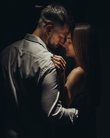 Portrait of young couple in love standing face to face in the corridor of the hotel