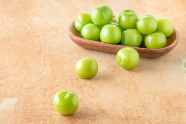 istock green plum fruits on table 1410215682