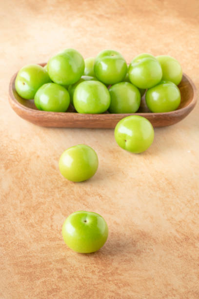 istock green plum fruits on table 1410215686