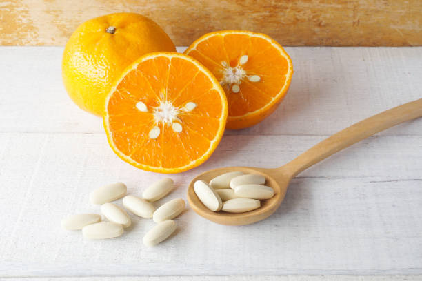 istock Vitamin C from orange on white wooden background. 1410216688