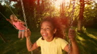 istock SLO MO Girl smiling swinging back and forth on a swing 1410220993