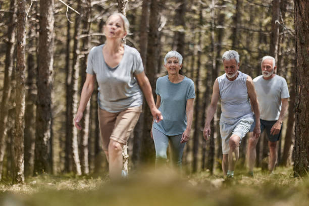 istock Group of active seniors walking through the woods. 1410223150