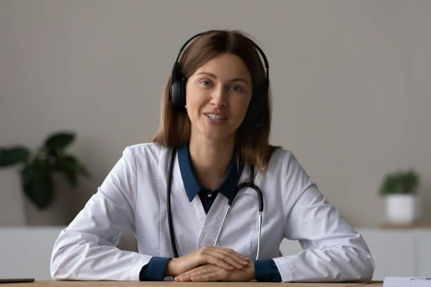 istock Female doctor in headset talk to patient from pc screen 1410223241