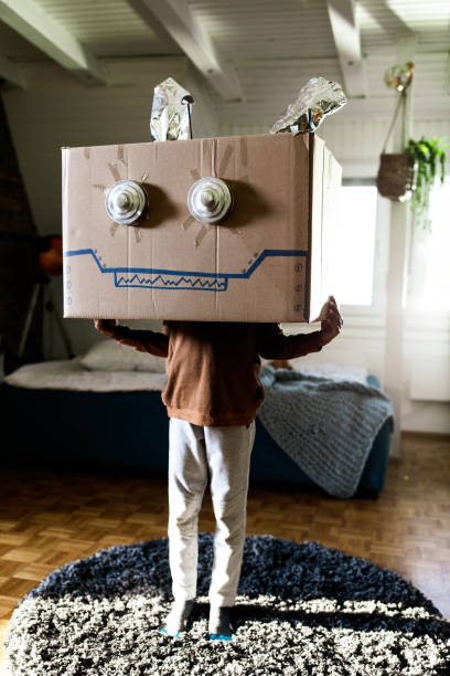 istock Small kid pretending to be a robot at home. 1410224178