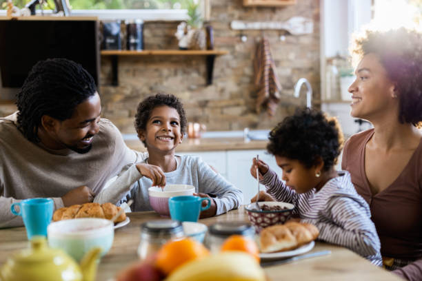 istock Happy black family talking while having breakfast in the morning. 1410224210