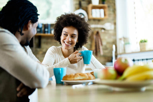 istock Young happy black couple communicating while enjoying in their coffee time. 1410224271