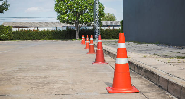 istock Orange traffic cones on cement road surface. 1410225196