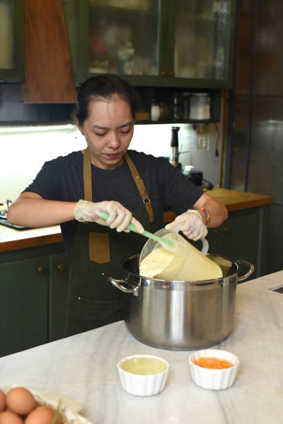 istock Young Vietnamese woman mixing  dough for a cake 1410226773