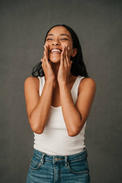 African American female rubbing her face with her hands