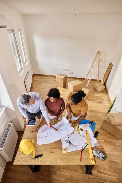 istock Above view of analyzing housing plan with an architect. 1410227181